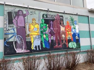 Mural on an outside wall on the campus of SUNY Purchase featuring a colorful NYC subway car scene