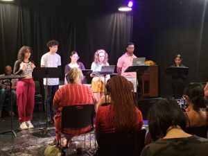 Students and actors in a table read of student's work