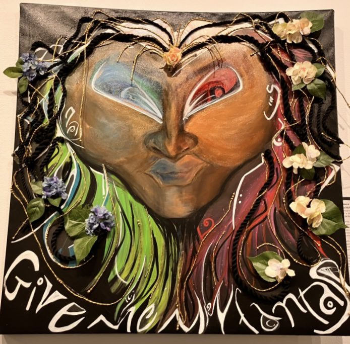 Mixed-media image of a face with flower in their hair by C. Joy Sanchez. 