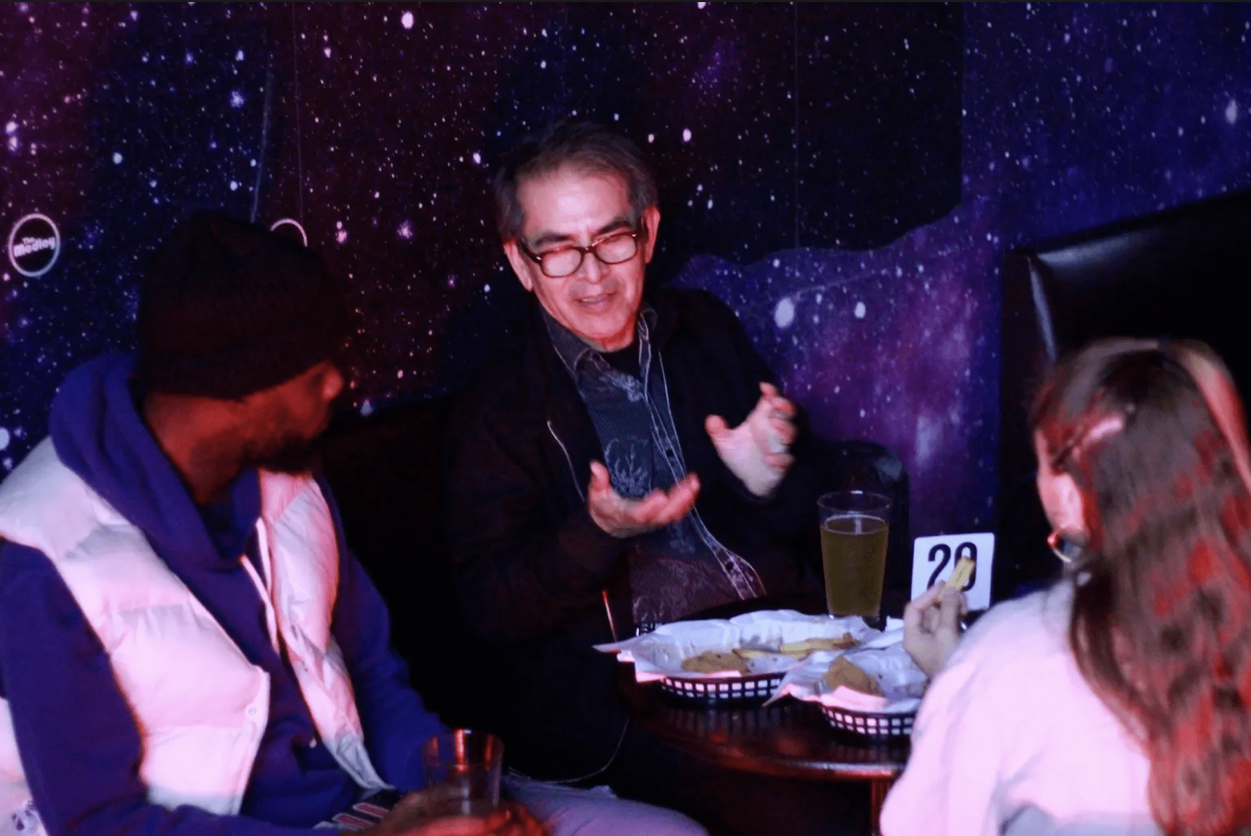 Artists seated at a table talking