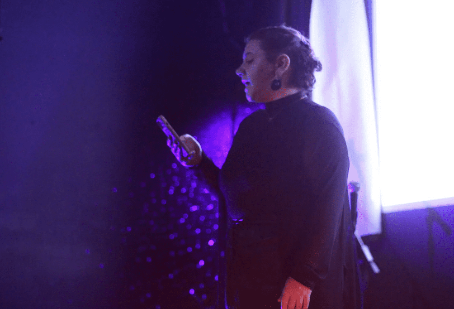 Spoken word performance by artist reading from their phone