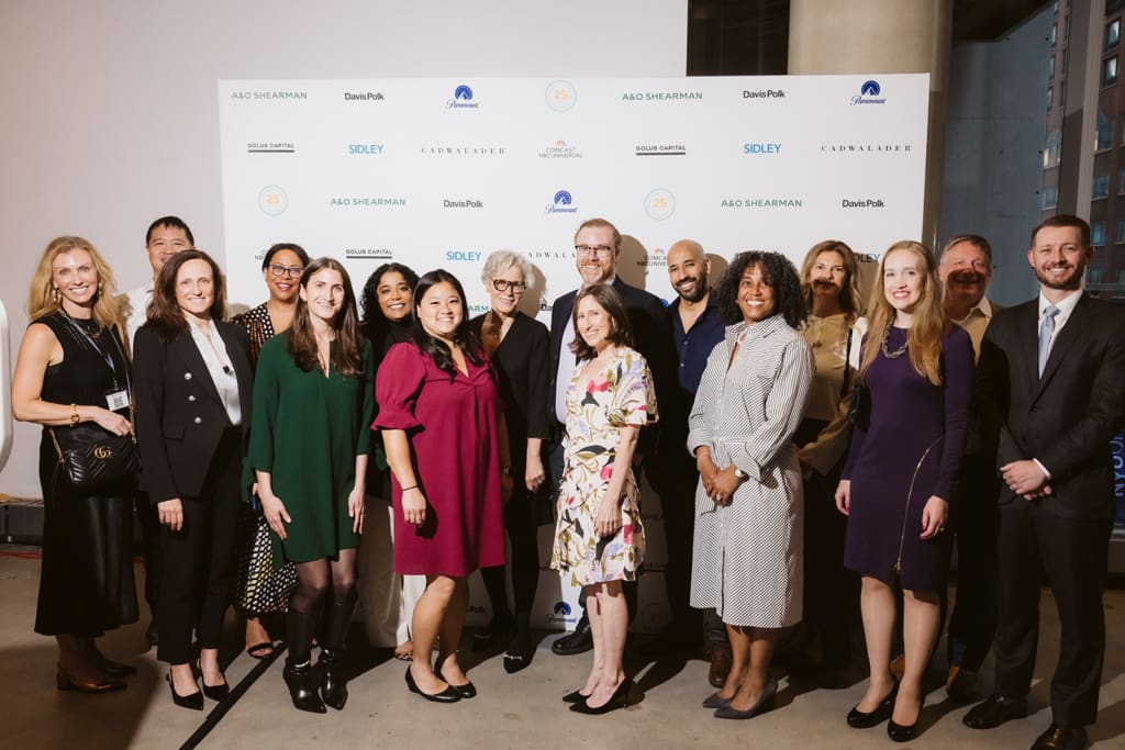 Members of our board of directors standing in front of a step and repeat.
