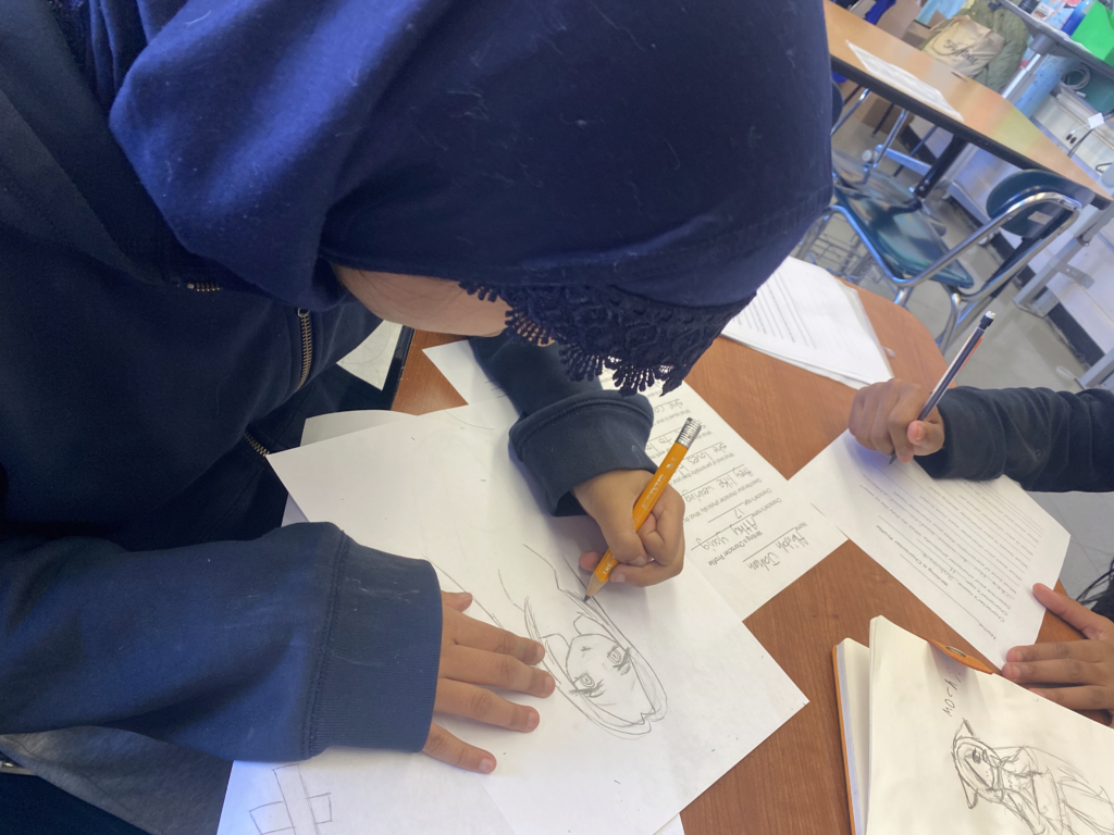Student drawing an imaginary character