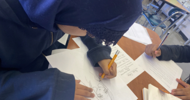 Student drawing an imaginary character