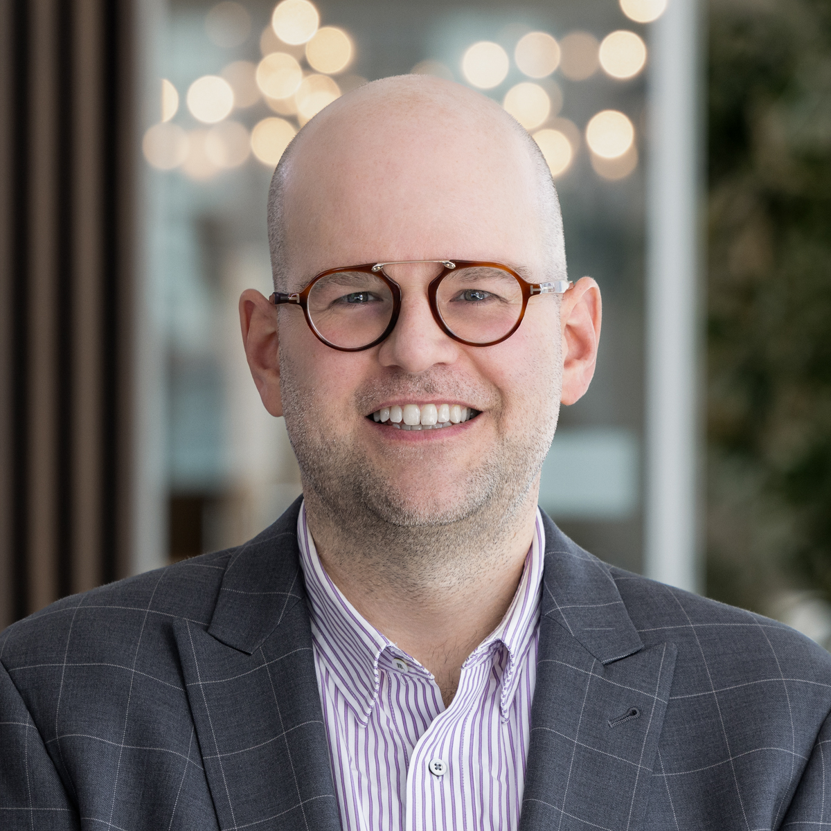Man in glasses smiling at camera