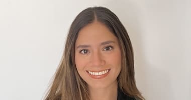 Woman smiling into camera on white background