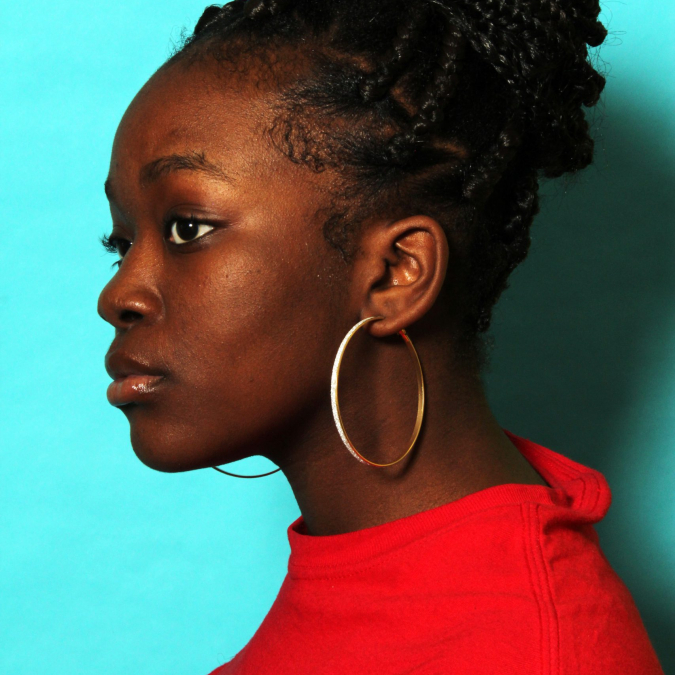 High school Black young woman in profile portrait with proud confident expression