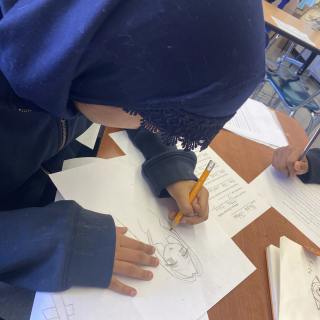 Student drawing an imaginary character